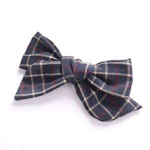 Detail view of handmade navy blue plaid cotton linen bow hair clip for girls