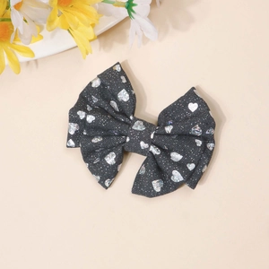 Detail of denim bow hair clip with silver heart sequins and double-layered structure