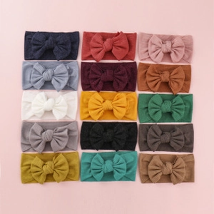 Set of 15 colorful corduroy bow headbands for baby girls in various soft candy colors
