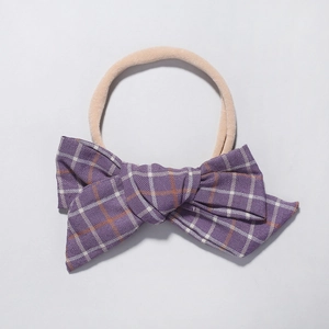 Close-up of purple plaid bow nylon headband with soft high-elastic nude band for babies