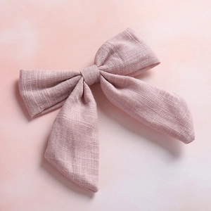 Detail of bamboo cotton texture and stitching on the pink swallowtail bow hair clip