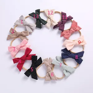 Set of 13 baby bow headbands featuring diverse polka dots and linen texture colors