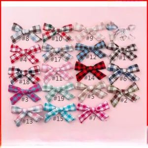 Detail view of colorful plaid pattern bow headbands for babies in 19 different styles