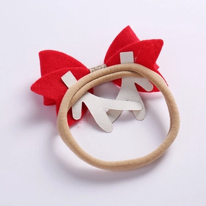 Weihnachts-Baby-Stirnband mit roter Schleife und Rentiergeweih auf beige elastischem Band