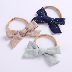 Three-piece baby bow headbands in navy, pink, and mint linen fabric with elastic nylon