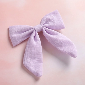 Close-up of light purple slub cotton swallowtail bow hair clip with textured fabric detail