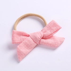 Pink cotton linen baby headband with white floral patterns and elastic nylon band
