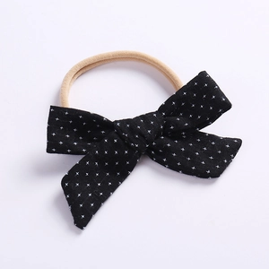Detail of baby headband with black cotton bow and pink high-elastic nylon hair band