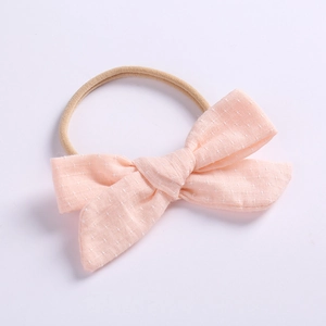 Detail of light pink linen cotton bow headband with high elasticity nylon for baby girls