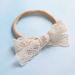 Fascia per capelli neonata con fiocco in pizzo e nylon elastico su sfondo blu