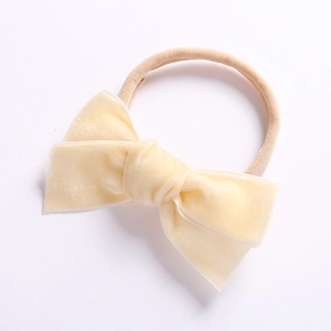 Detail von weichem beigem Samtschleife-Babystirnband mit hochelastischem Nylon-Band