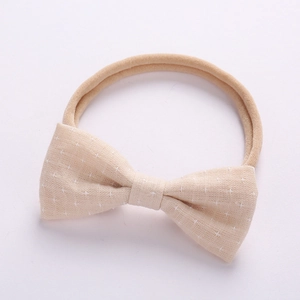 Close-up of baby bow headband made of bamboo cotton with star pattern and soft nylon band
