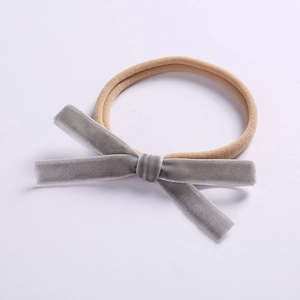 Detail of grey velvet bow hairband with a soft high-elastic nylon strap for infants