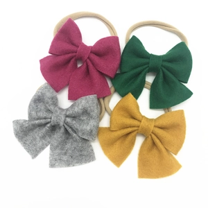 Set of four baby nylon headbands with large non-woven fabric bows in assorted colors