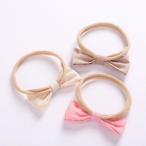 Three-piece set of baby bow headbands in pink, beige and brown with star patterns