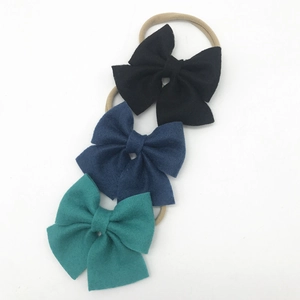 Three-piece baby nylon headbands set with large fabric bows in black, blue, and teal