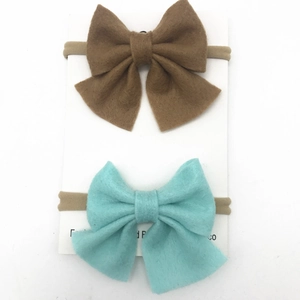 Detail of baby nylon headbands with brown and light blue felt butterfly bows on display card