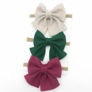 Three-piece baby bow headband set with wool felt bows in cream, green and purple