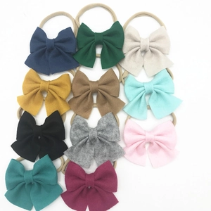 Detailed set of 11 assorted colored nylon elastic baby headbands with large textured bows