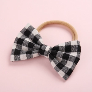 Bandeau souple pour bébé en nylon avec un nœud décoratif à carreaux noirs et blancs