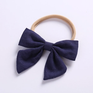Detail of navy blue cotton linen bow and soft stretch nylon baby headband