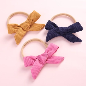3-pack of newborn corduroy bow headbands in yellow, navy blue, and pink colors