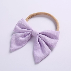 Soft linen bow baby headband in light purple with elastic nylon band on white background