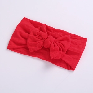 Detailed view of the large red bow knot on a soft high-elastic nylon baby headband
