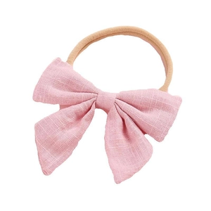 Soft nylon baby headband with a pink cotton linen bow displayed on a white background