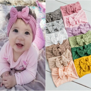 Detail of soft nylon baby headbands with large bows in various colors for infants