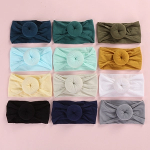 Set of 12 soft nylon headbands for babies featuring cute donut knots in various colors
