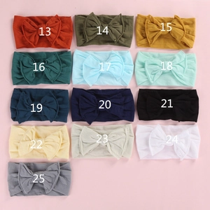 Matrix display of baby bow headbands in 13 various colors with soft stretchy fabric