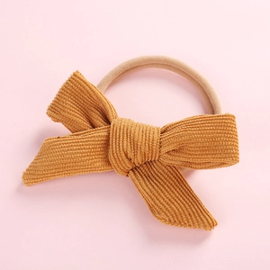 Close-up of mustard yellow corduroy bow headband with high elasticity seamless band