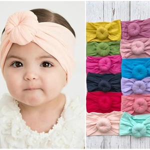 Macro detail of elastic nylon baby headbands with donut knot in twelve vibrant colors