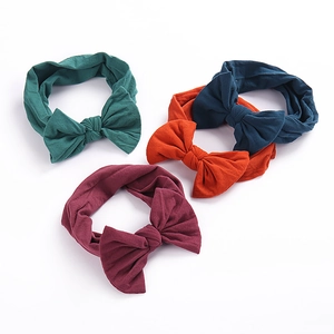 Set of 4 soft nylon baby headbands with large bows in dark green, navy, orange and maroon