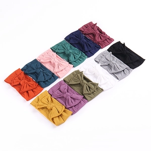 Close-up showing colorful soft knitted cotton baby headbands with large bow details