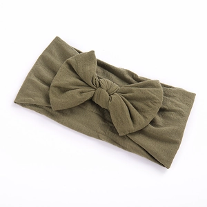 Detail of soft olive green nylon baby headband with stretchable knotted bow design