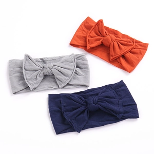 Three-piece set of wide elastic baby headbands with soft fabric bows in various colors