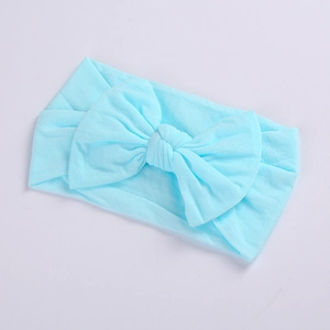 Close-up of a soft light blue nylon baby headband with a large decorative bow