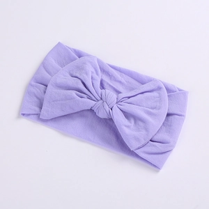 Detail of soft purple nylon baby headband featuring a large textured ribbed bow