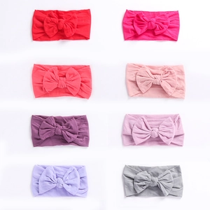 Detail showing set of 8 soft nylon headbands with large bows for infants in various colors