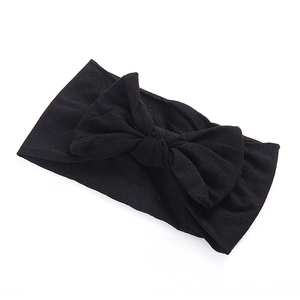 Soft nylon stretchy headband for babies featuring a large solid black bow decoration