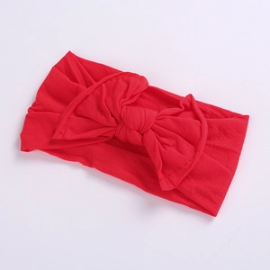 Close-up of red elastic nylon baby headband featuring a soft large bow knot detail