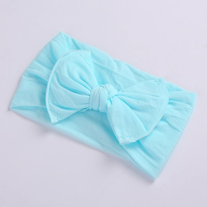 Close-up of soft light blue baby headband featuring a large knitted bow detail