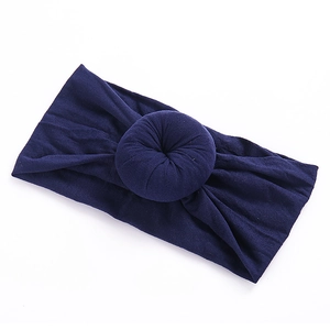 Detail of dark blue baby donut headband made of soft stretchy nylon with twisted knot