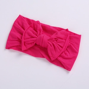 Detailed view of rose red baby headband featuring soft ribbed fabric and a large bow knot
