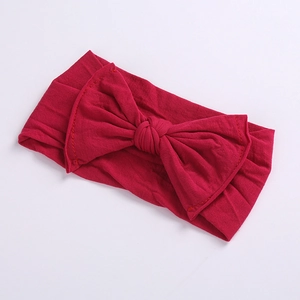 Detailed view of dark red wide fabric headband with double layer bow and stitching