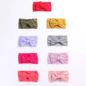 Set of nine colorful soft elastic baby headbands with large ribbed fabric bows
