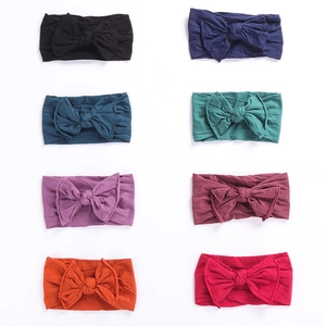 Set of 8 colorful baby nylon headbands with cute bows in a tidy matrix display