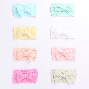 Set of eight soft elastic infant headbands in pastel colors with large knit bows